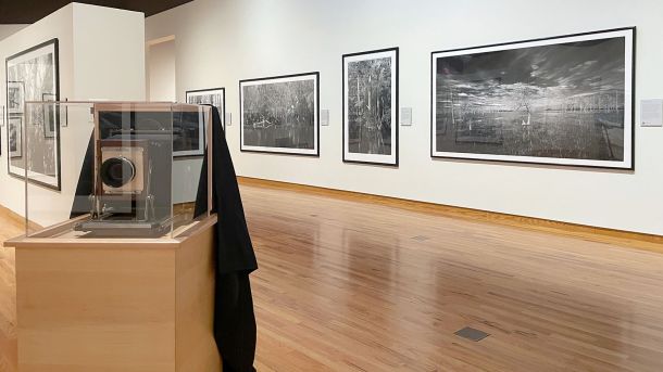 The style of camera used by Clyde Butcher is shown alongside some of his prints of the Florida Everglades at Fort Wayne Museum of Art.