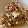 The tostada with braised chicken, chipotle, rhubarb pico, cotija cheese, and crème fraîche delivers a balance of flavors and textures.