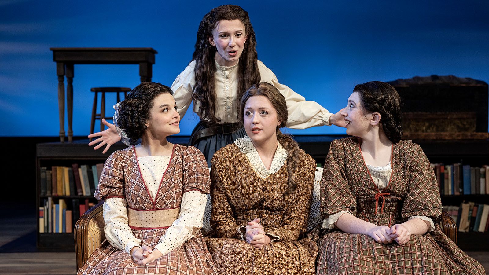 Olivia Albertson, standing, shares a scene with, from left, Wren Rogers, Abby Coates, and Erin Butler in PFW’s production of Little Women: The Musical.